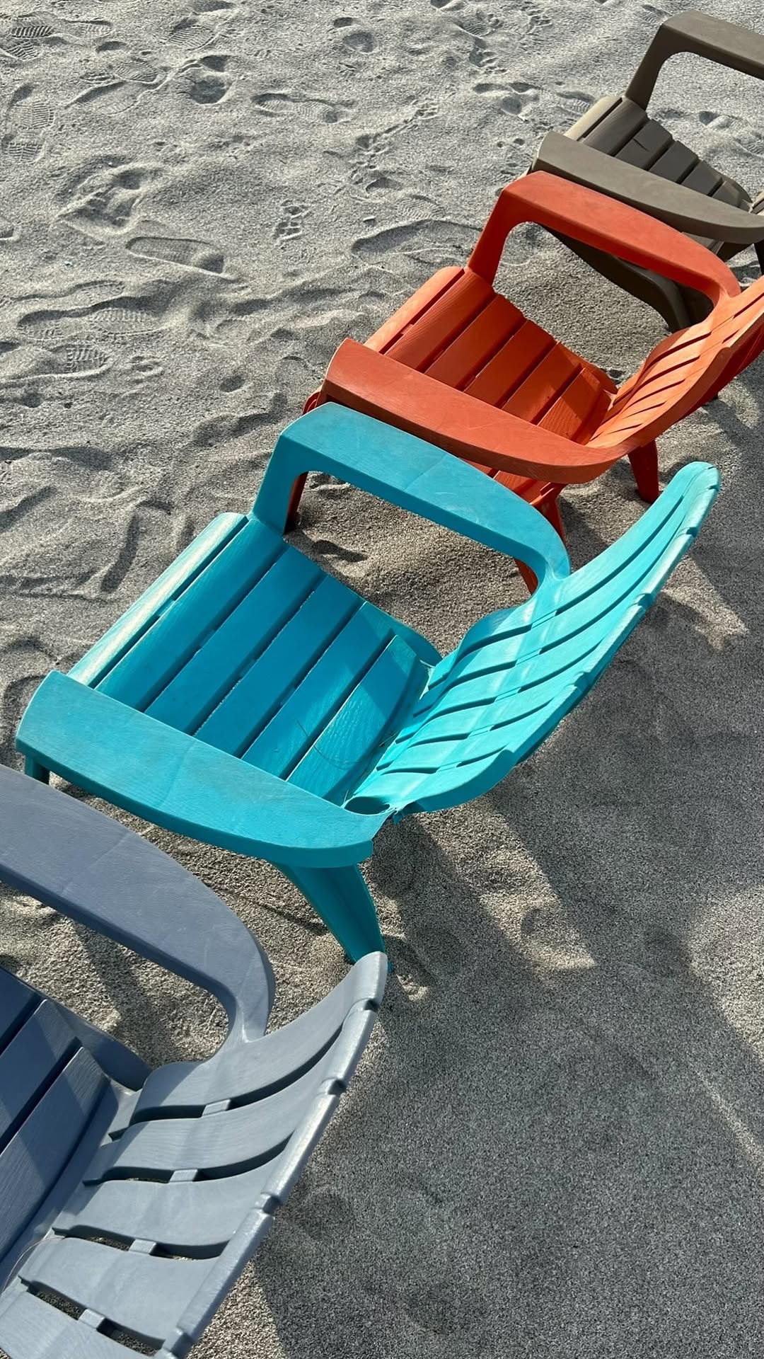 Beach lounge chairs on white sand
